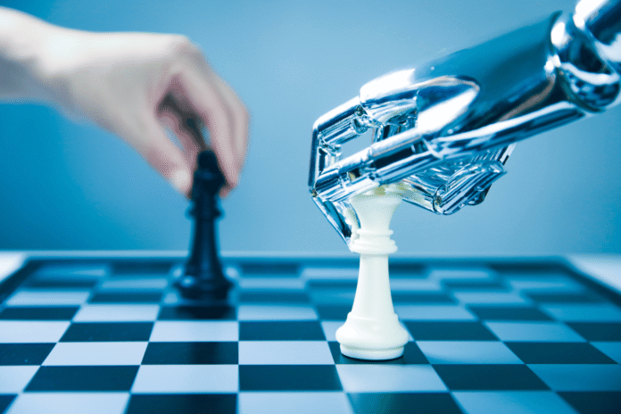 Robotska ruka i ljudska ruka igraju šah, simbol debate o AI pravima i kontroli
